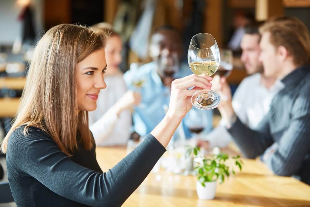 Woman examining wine glass